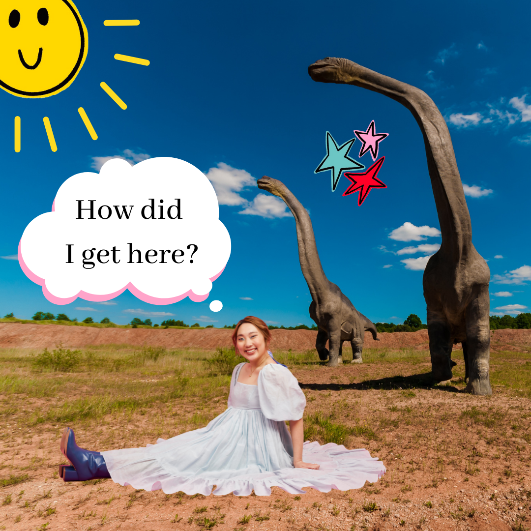 A young woman edited in front of some dinosaurs with a thought bubble that says "How did I get here?"